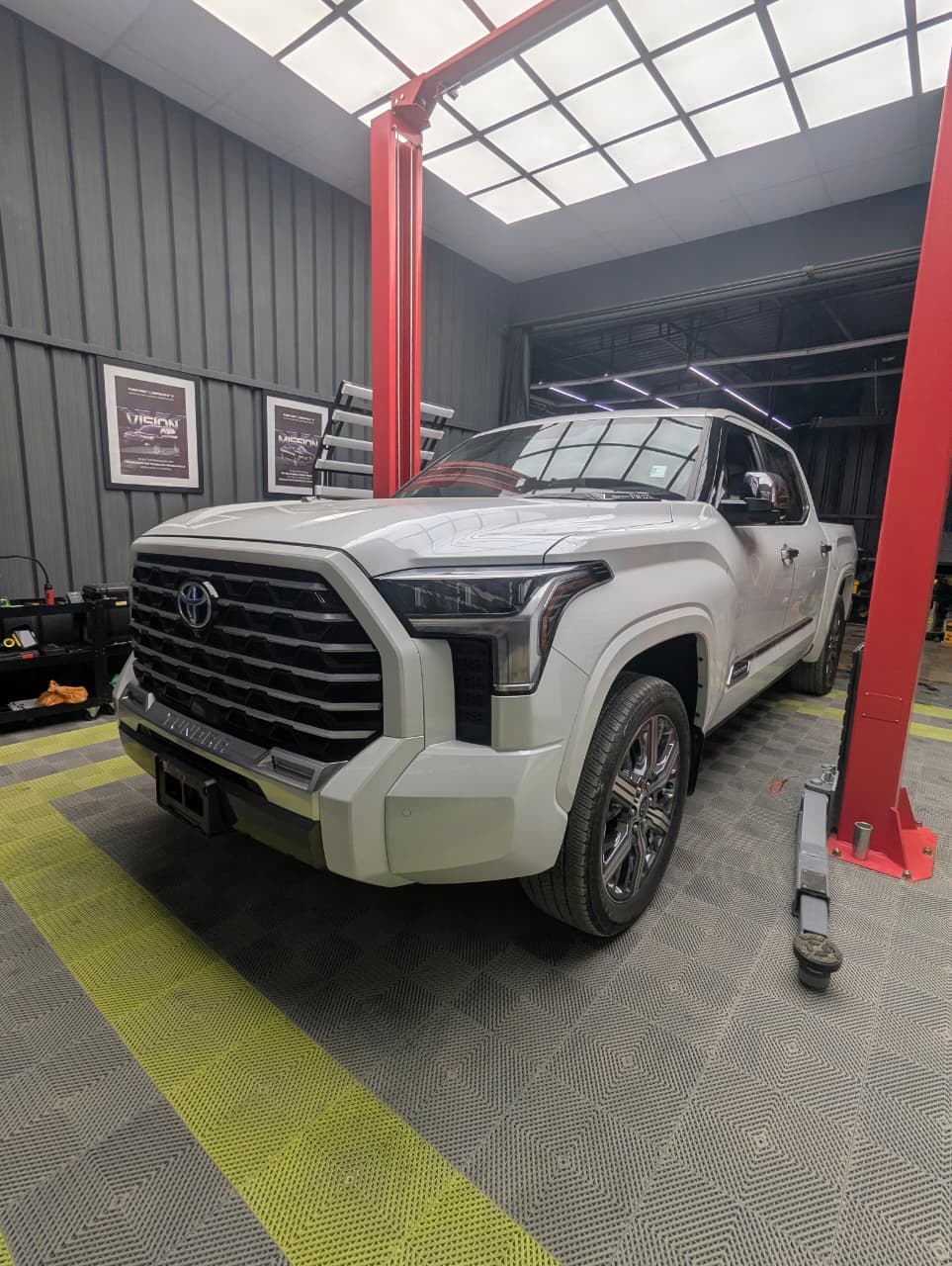 A vehicle undergoing UV-scan diagnostic inspection at the Tweak X Inspect centre